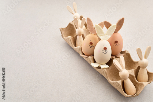 Zero waste Easter. Easter egg bunnies and wooden figures in carton