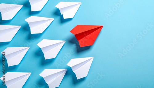 Red paper airplane diverging from white group on blue background, symbolizing innovation, leadership, and breaking away from the norm.