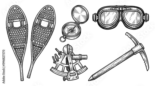 A set of snowshoes, goggles, compass, pickaxe, and crampons for winter mountain exploration.