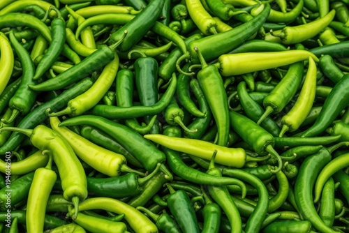 Fresh Green Chili Peppers Pile Full Frame Background, Vibrant Spicy Hot Pepper Market Texture