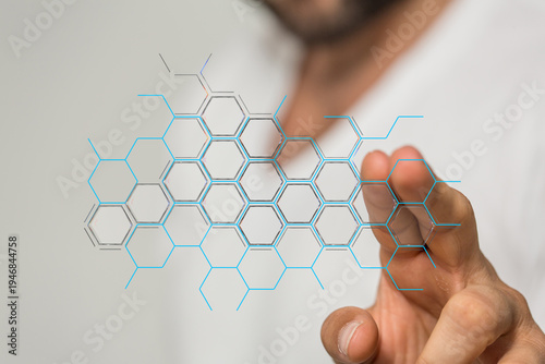 Close-up of a man's hand interacting with a digital interface. The image features a network concept, futuristic technolo
