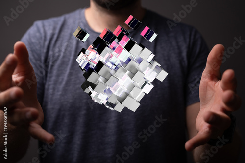 Man holding a 3D cube illus...