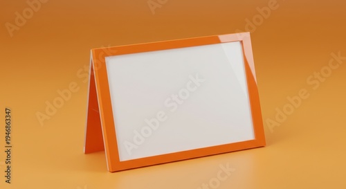 Modern orange picture frame on an orange surface offers a blank canvas for creative expression