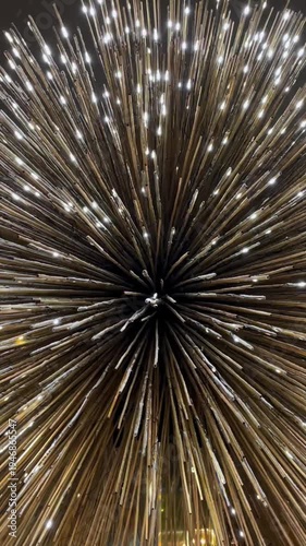 A glowing burst of golden particles forming dynamic trails and sparkling light rays