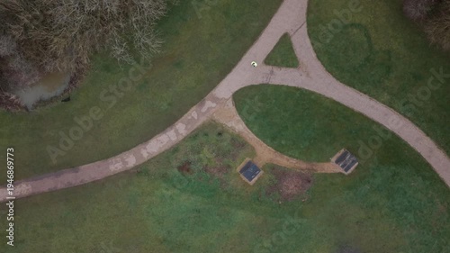 Runner running through the park, past a bench