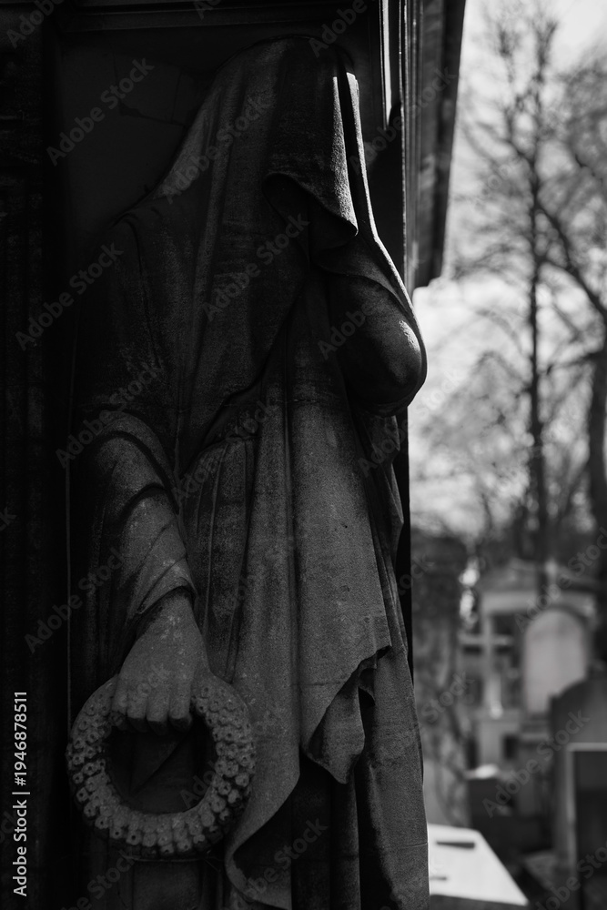 Naklejka premium Old European Graveyard with tombstones, crosses and religious symbols, spooky atmosphere, black and white, Pere la Chaise Cemetery, Paris France
