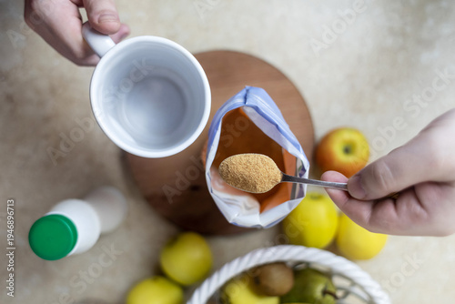 Wallpaper Mural Person adding apple fiber powder to a glass of yogurt, surrounded by fresh apples and walnuts. Healthy prebiotic supplement for gut health, digestion and weight management. Torontodigital.ca