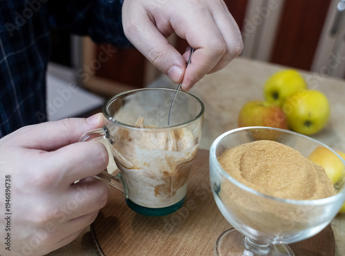 Wallpaper Mural Person adding apple fiber powder to a glass of yogurt, surrounded by fresh apples and walnuts. Healthy prebiotic supplement for gut health, digestion and weight management. Torontodigital.ca