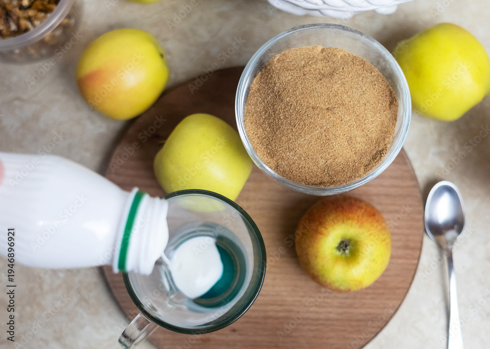 custom made wallpaper toronto digitalPerson adding apple fiber powder to a glass of yogurt, surrounded by fresh apples and walnuts. Healthy prebiotic supplement for gut health, digestion and weight management.