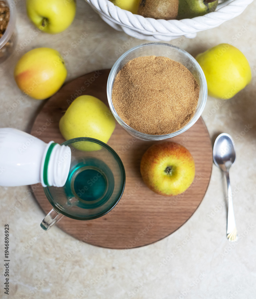 custom made wallpaper toronto digitalPerson adding apple fiber powder to a glass of yogurt, surrounded by fresh apples and walnuts. Healthy prebiotic supplement for gut health, digestion and weight management.