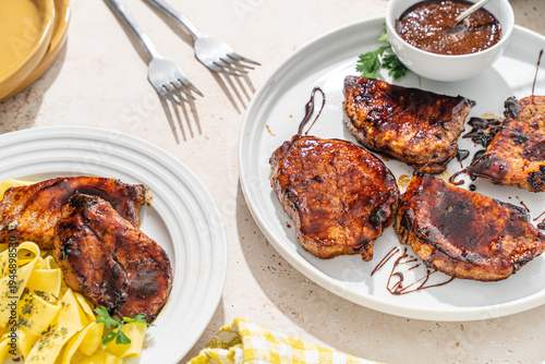 Obraz na płótnie Barbecue pork chop dinner with bbq sauce drizzle
