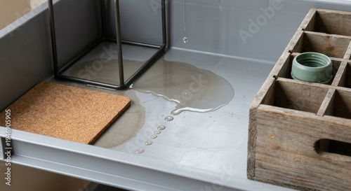 Water puddle and drip on a metal storage shelf