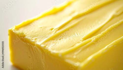 Creamy yellow butter block, soft spread marks, rectangular piece, smooth glossy surface