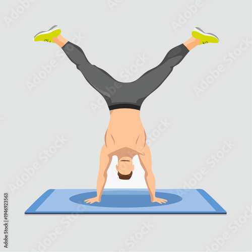 Man performing a handstand with legs apart on a yoga mat