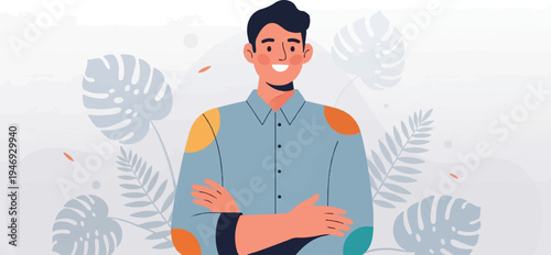 A smiling man in a blue shirt with colorful patches, arms crossed, and tropical leaves in background