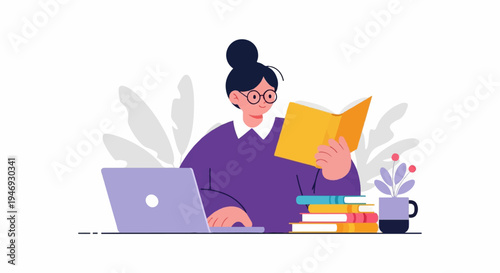 A person wearing glasses sits at a desk with a laptop and reads a book