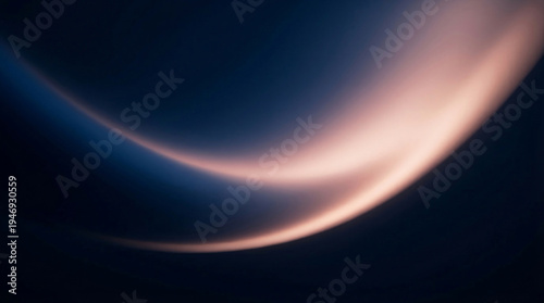 Abstract light forms a graceful, flowing curve, reminiscent of soft silk draping smoothly in a mesmerizing dance of luminous warmth against a deep, dark expanse