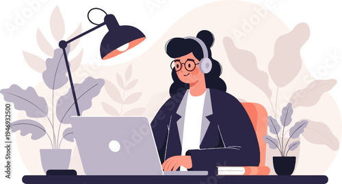 A person in headphones and glasses works on a laptop at a desk with plants and a lamp