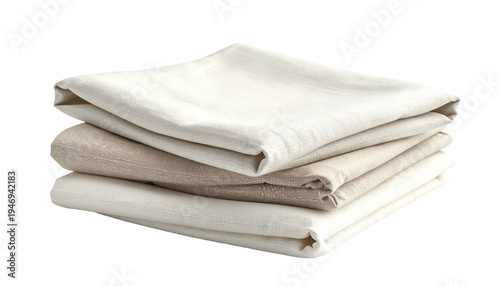 A stack of folded fabric in varying light neutral shades, against a dark backdrop