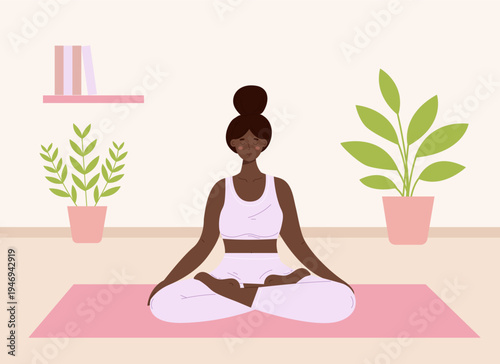 A young black woman practicing yoga at home. African american female in lotus pose or Padmasana sitting on a mat in a cozy room with plants. Mental health and wellness.