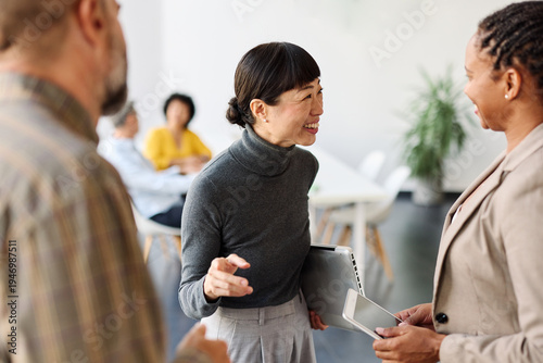 Group of young business people having a meeting or presentation and seminar standing in the office. Portrait of a young business woman talking