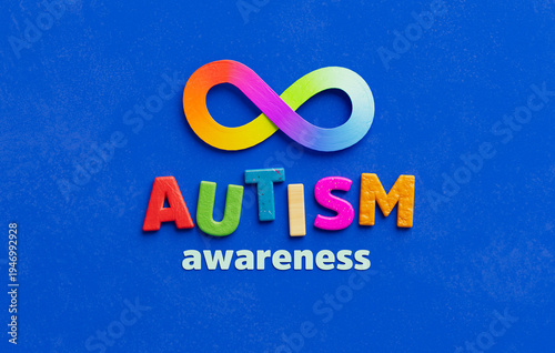 Colorful autism awareness design with rainbow infinity symbol on blue background, representing neurodiversity acceptance and inclusive support campaign message in 3D illustration