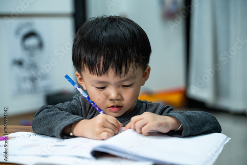 Toddler Practicing Writing with Pencil at Table