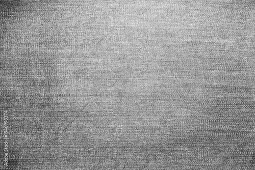 High-quality close-up of grey denim fabric texture with natural faded effect. Detailed cotton textile weave background for fashion, apparel, and industrial design concepts.