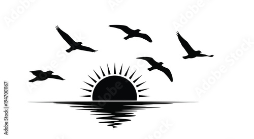 Birds in flight over water and sun a striking silhouette