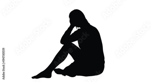 A woman sits with her head in her hand a stark silhouette