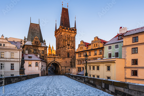 Photography Mala Strana Bridge Tower on the UNESCO world heritage site Charles Bridge in Prague on a winter cold morning sunrise in strong sunlight