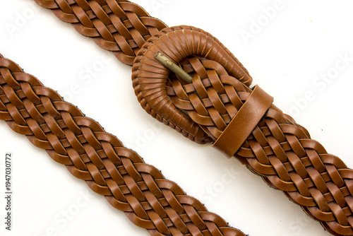 Elegant woven leather belt isolated on white background. It adds sophisticated style to any outfit, perfect for fashion and accessory collections.