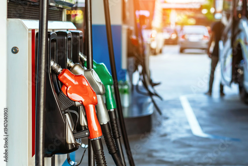 Petrol fuel nozzle for fuelling in petrol fuel station. Hand refilling car with fuel at gas station. Nozzle pump petroleum fuel. Fuel dispensing pump. Fuel and Business service energy concept.