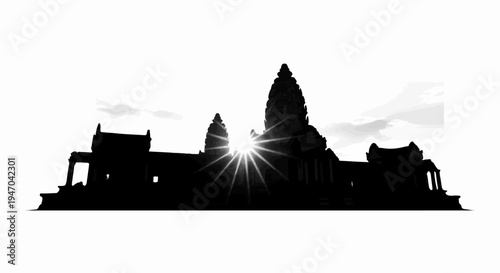 Black silhouette of ancient temple complex with sunburst at dawn