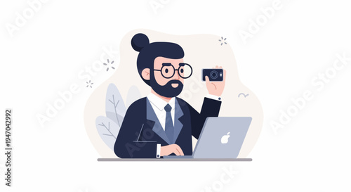 Bearded man in suit with glasses holding camera, working on laptop