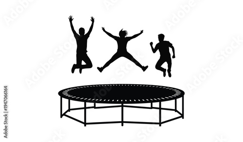 Three people silhouette jumping high in the air above a large circular outdoor bouncy trampoline