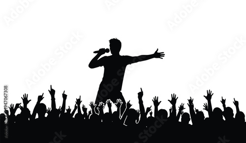 A silhouette of a male singer performing on stage with a cheering crowd of fans raising their hands