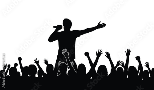 A silhouette of a male singer performing on stage with a cheering crowd raising their hands high