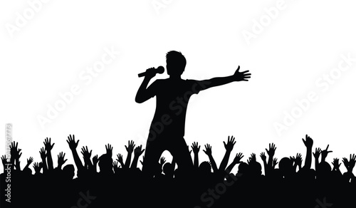 A silhouette of a male singer performing on stage in front of a cheering crowd at a music concert