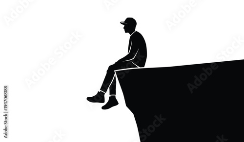 A silhouette of a lone person wearing a cap sitting on the edge of a high cliff looking forward