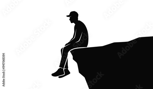 A silhouette of a lonely person wearing a baseball cap sitting on the edge of a high cliff top