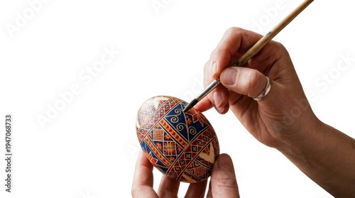 Decorating traditional pysanka easter egg with folk patterns