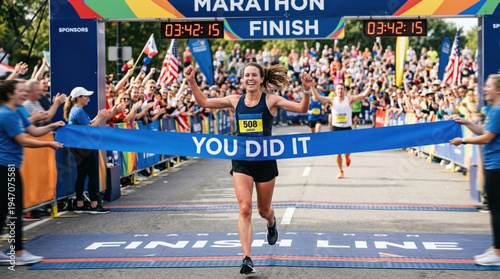 Female runner crossing finish line celebrating race achievement
