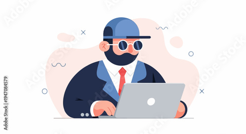 Bearded man wearing a cap and glasses, working on a laptop