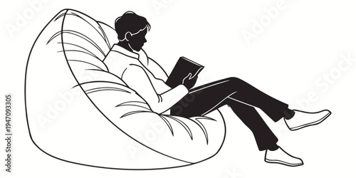 A person relaxing in a bean bag chair while reading a book.