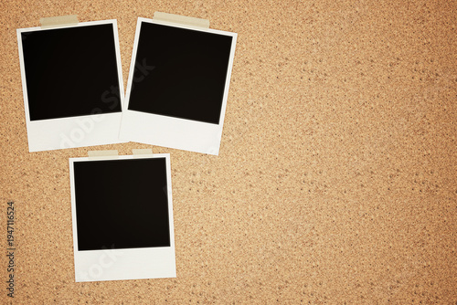 Three Blank Polaroid Photo Frames Taped on Cork Board with Copy Space