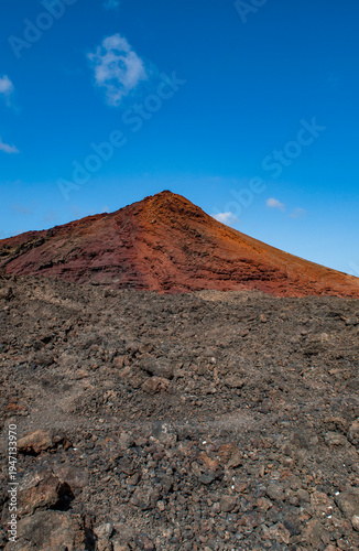 Lanzarote, Canary Islands: breathtaking desert landscape and red mountain in Timanfaya National Park (Parque Nacional de Timanfaya), famous geological park entirely made up of volcanic soi