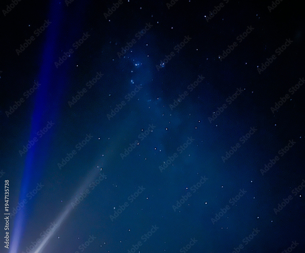 Fototapeta premium A beautiful image of the night sky with rays of light and stars. Space for creative text and advertising. Copy space 