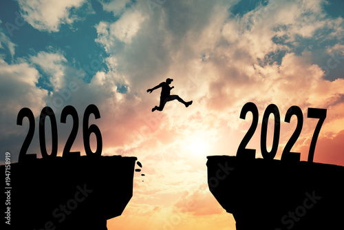 Canvas Print Silhouette of a person jumping between the years 2026 and 2027, symbolizing progress and moving forward