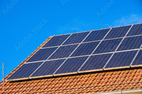 Solar panels generating clean energy on house roof